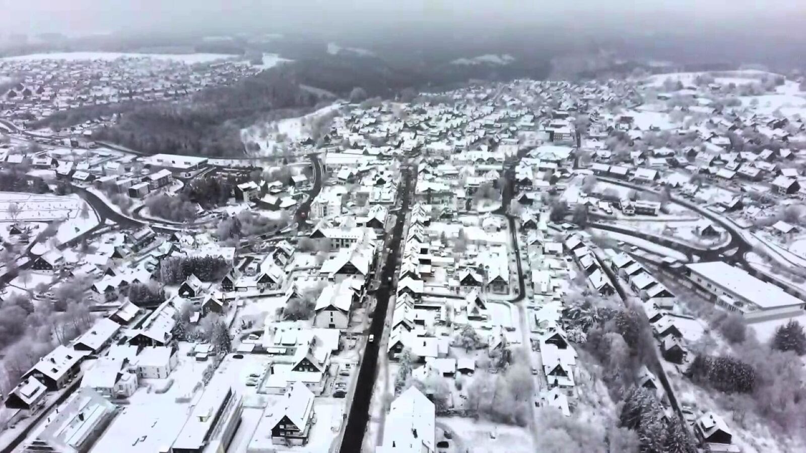 An aerial view of a residential area with houses and roads.