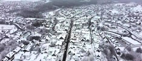 An aerial view of a residential area with houses and roads.