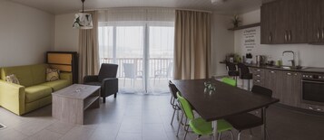 Apartment, Sea View | Living area | Flat-screen TV