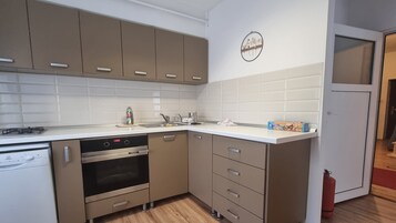 A modern kitchen with stainless steel appliances, a dishwasher, and a built-in oven.