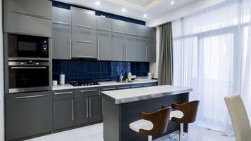 Family Apartment, 3 Bedrooms | Private kitchen | Fridge, microwave, coffee/tea maker, highchair