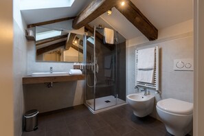 Junior suite | Badkamer | Een douche, een bidet, handdoeken