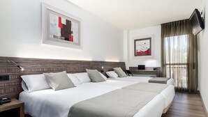 A hotel room with a large bed, bedside tables, a flat-screen TV, and artwork on the walls. - Hotel HC Mollet Barcelona (Mollet del Valles)