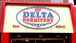 A sign for "DD DELTA DORMITORY" with decorative elements and text in English and Hindi. - Delta Dormitory - Hostel (Mumbai)