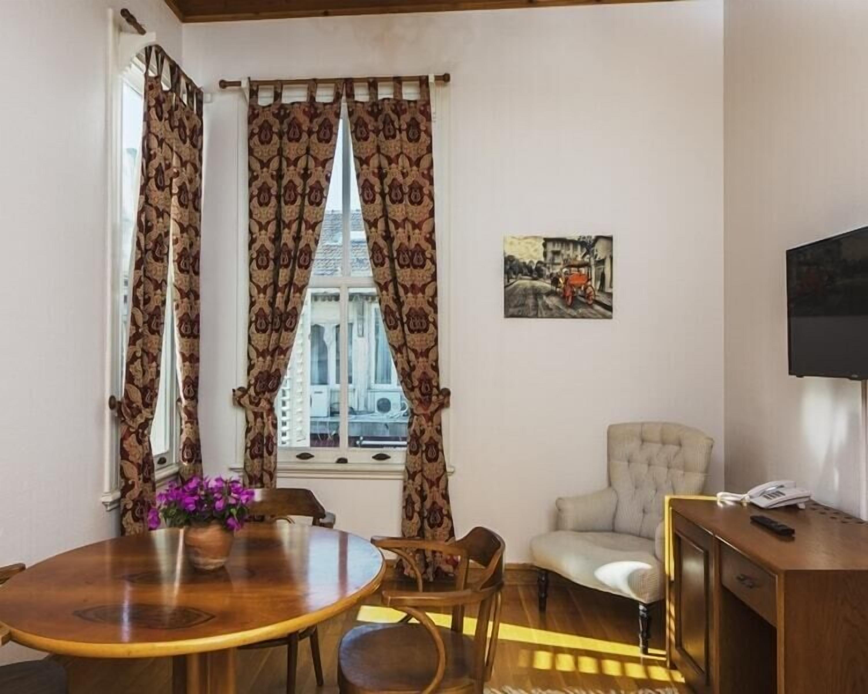 family quadruple room | living area | flat-screen tv