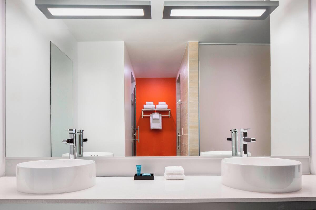 shower, designer toiletries, hair dryer, towels