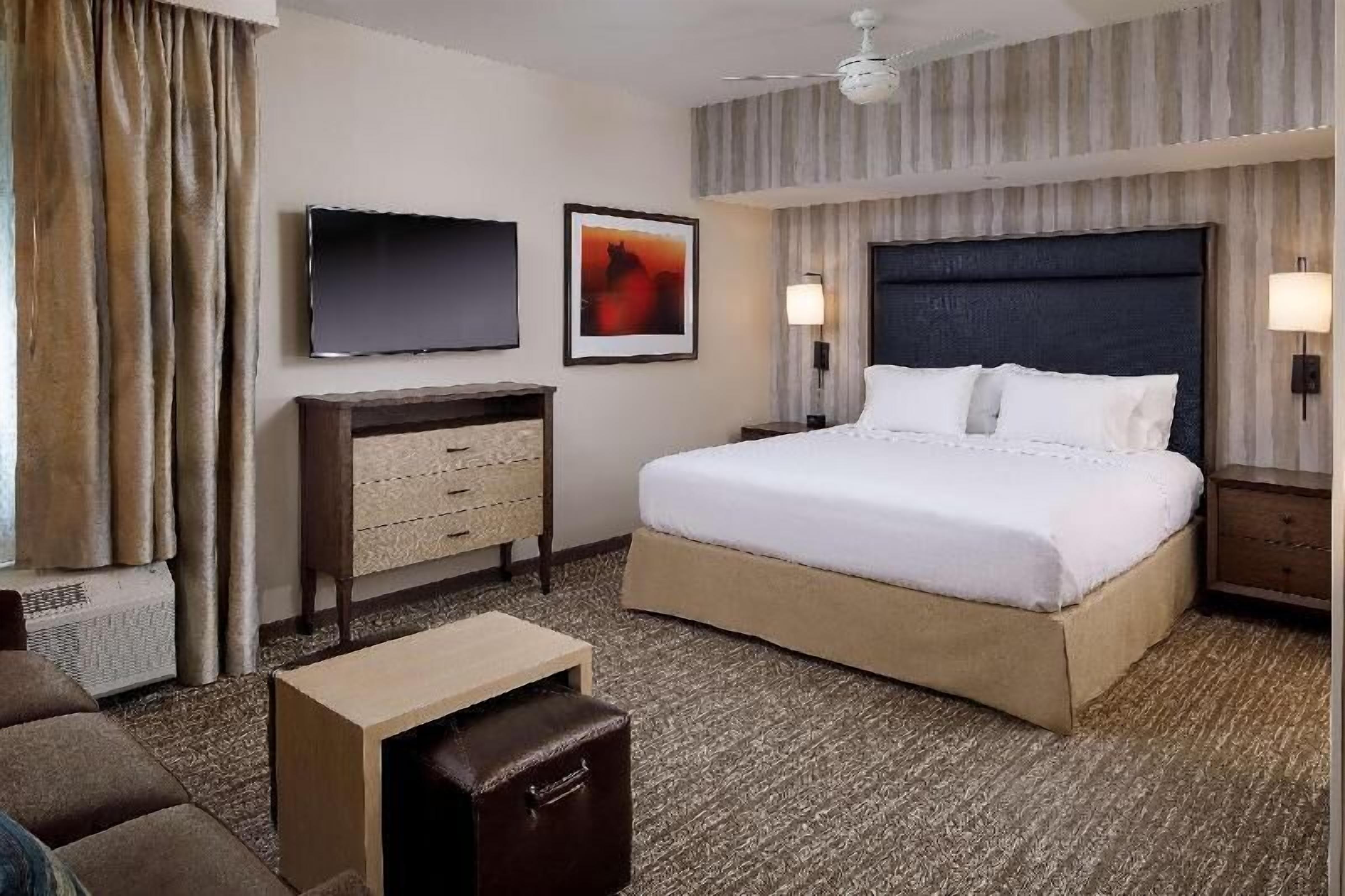 Premium bedding, desk, laptop workspace, blackout drapes