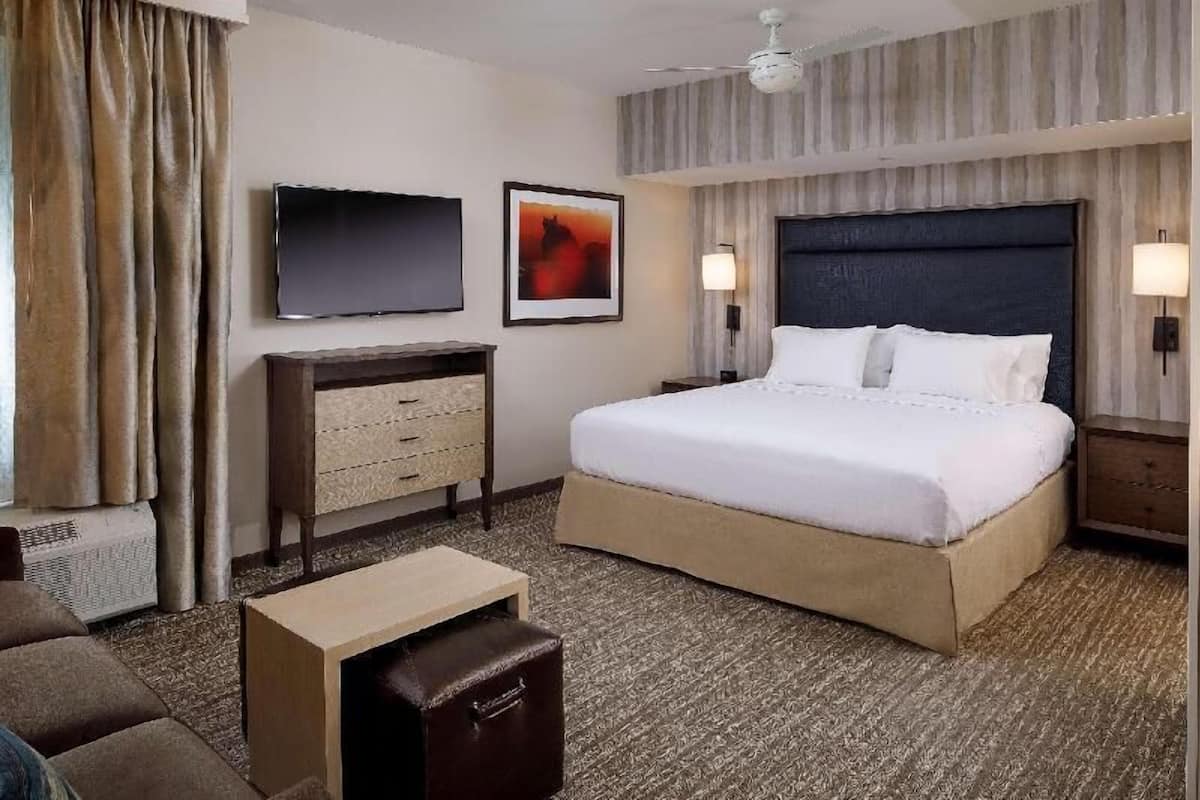 Premium bedding, desk, laptop workspace, blackout drapes