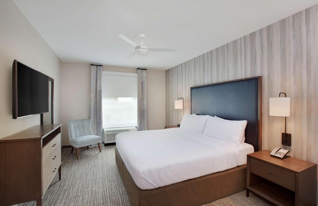 Premium bedding, desk, laptop workspace, blackout drapes