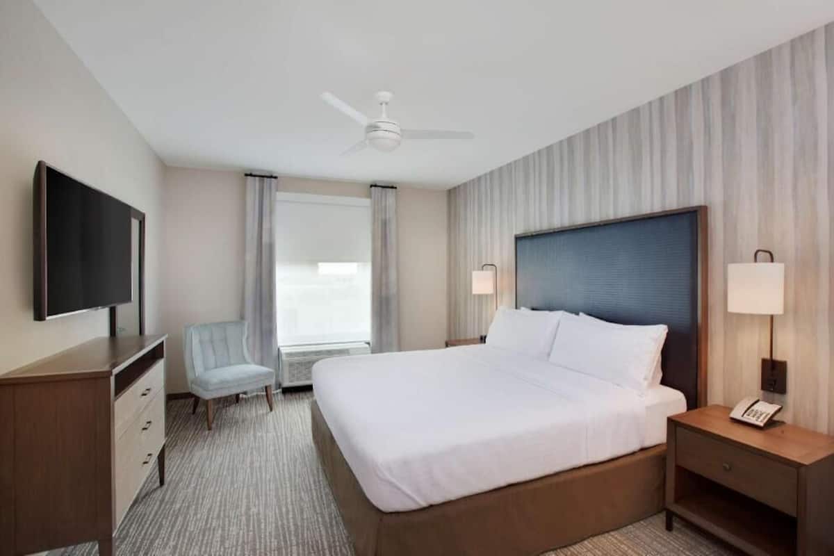 Premium bedding, desk, laptop workspace, blackout drapes