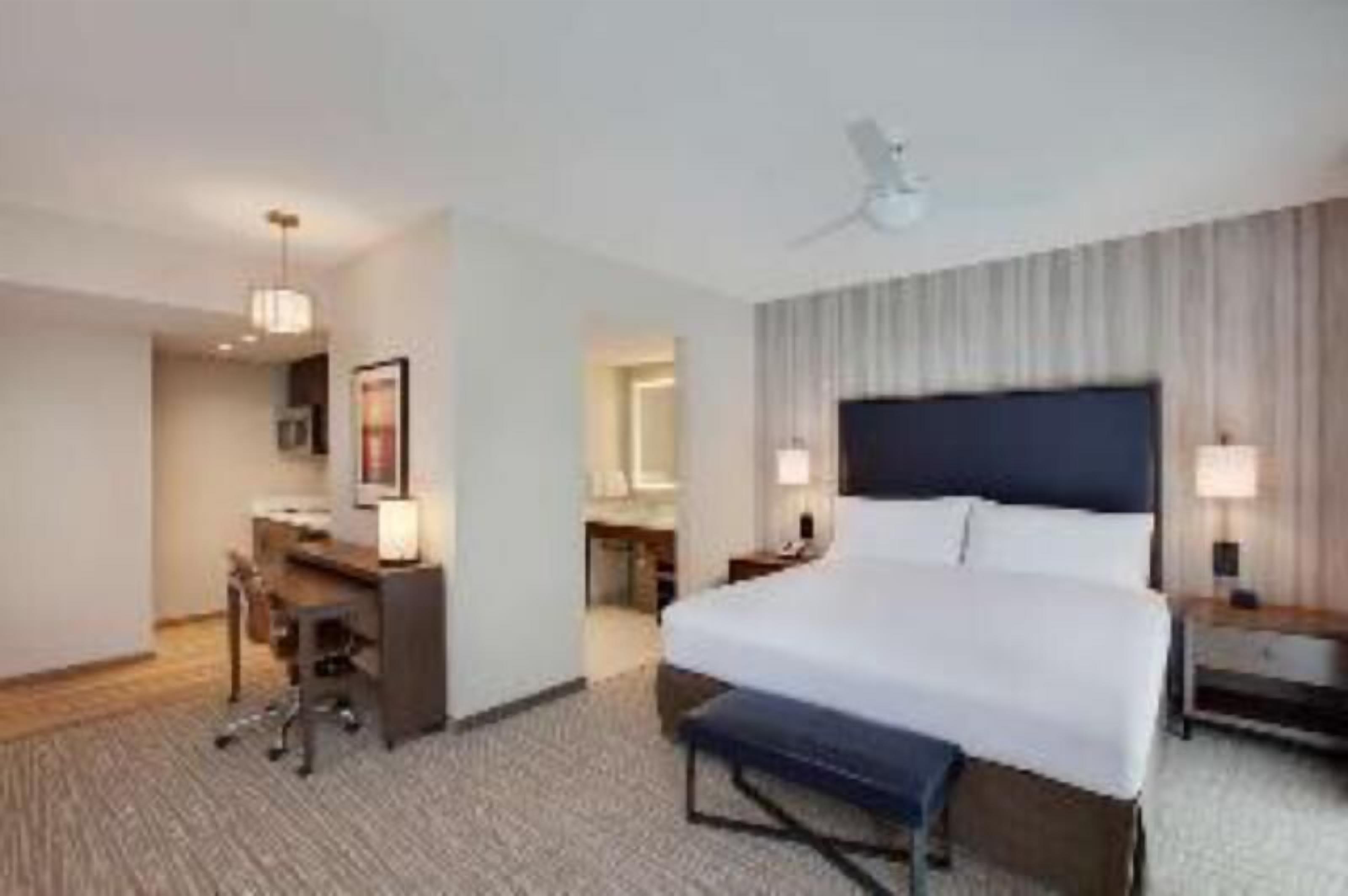 Premium bedding, desk, laptop workspace, blackout drapes