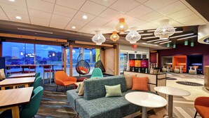 A modern lounge area with a sofa, chairs, and tables.