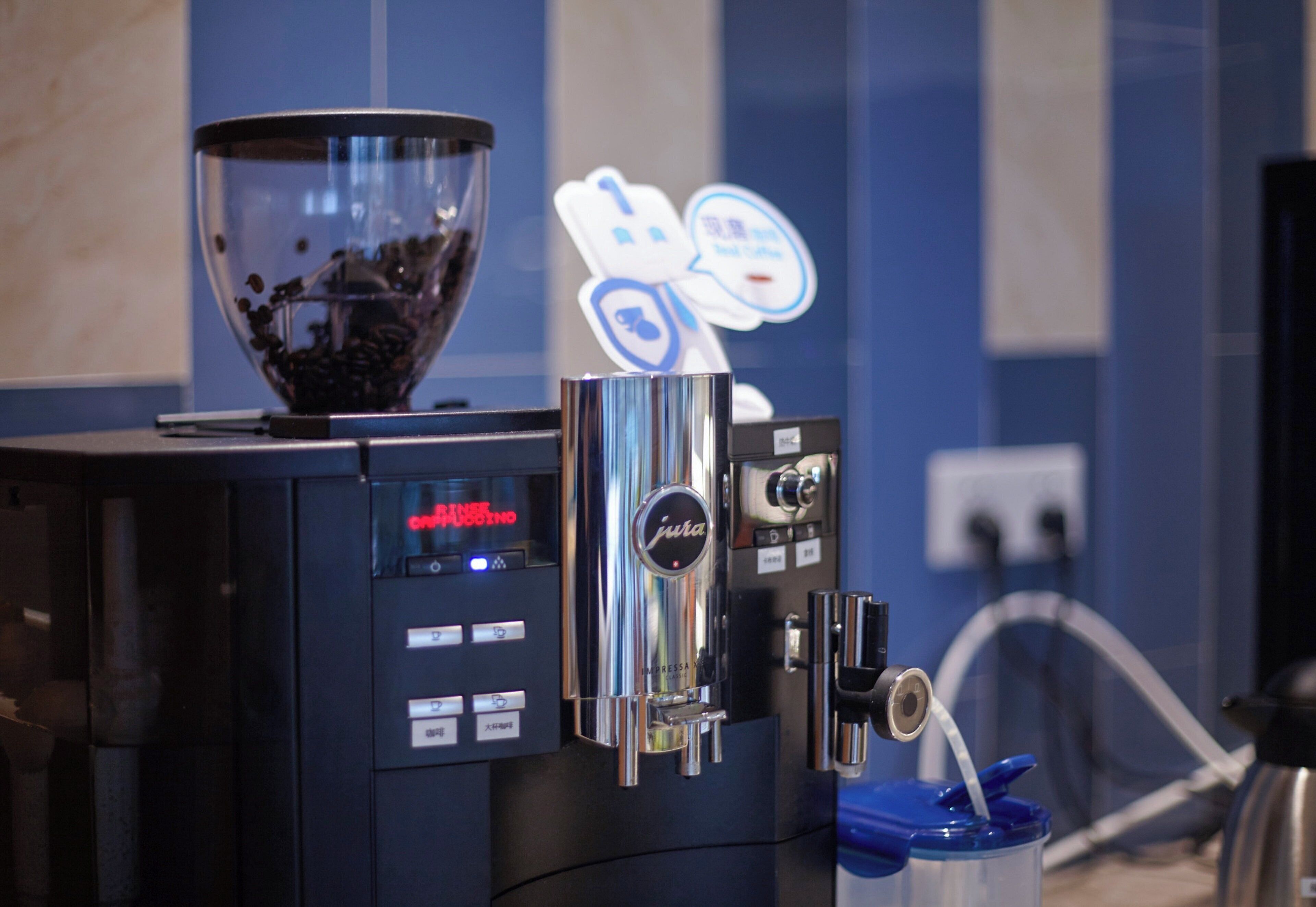 A coffee machine with a digital display and a coffee bean hopper.