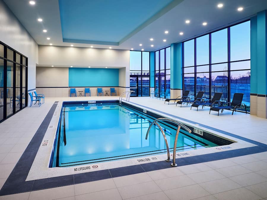Indoor pool, open 7:00 AM to 11:00 PM, pool loungers