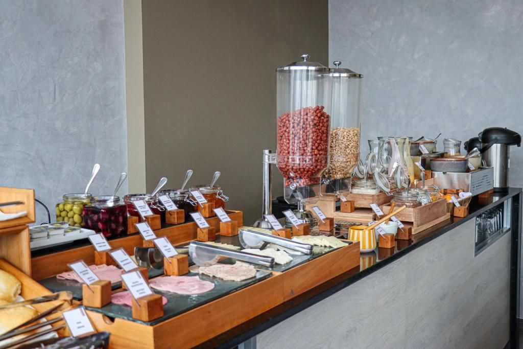 A buffet with various food items and condiments.