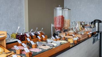 A buffet with various food items and condiments.