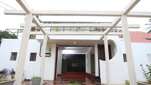 A covered entrance with a tiled floor leading to a building.