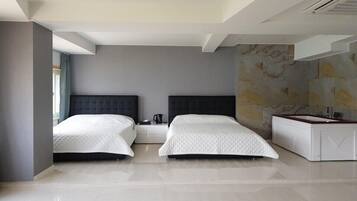 A modern hotel room with two beds, a large mirror, and a marble wall.