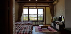 A room with two beds, a bench, a TV, and a balcony with a view. - Jun House - Hostel (Jeju City)
