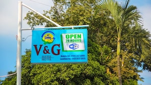 Señal para V&G Suites Hotel publicitando Wi-Fi las 24 horas y abierto las 24 horas.