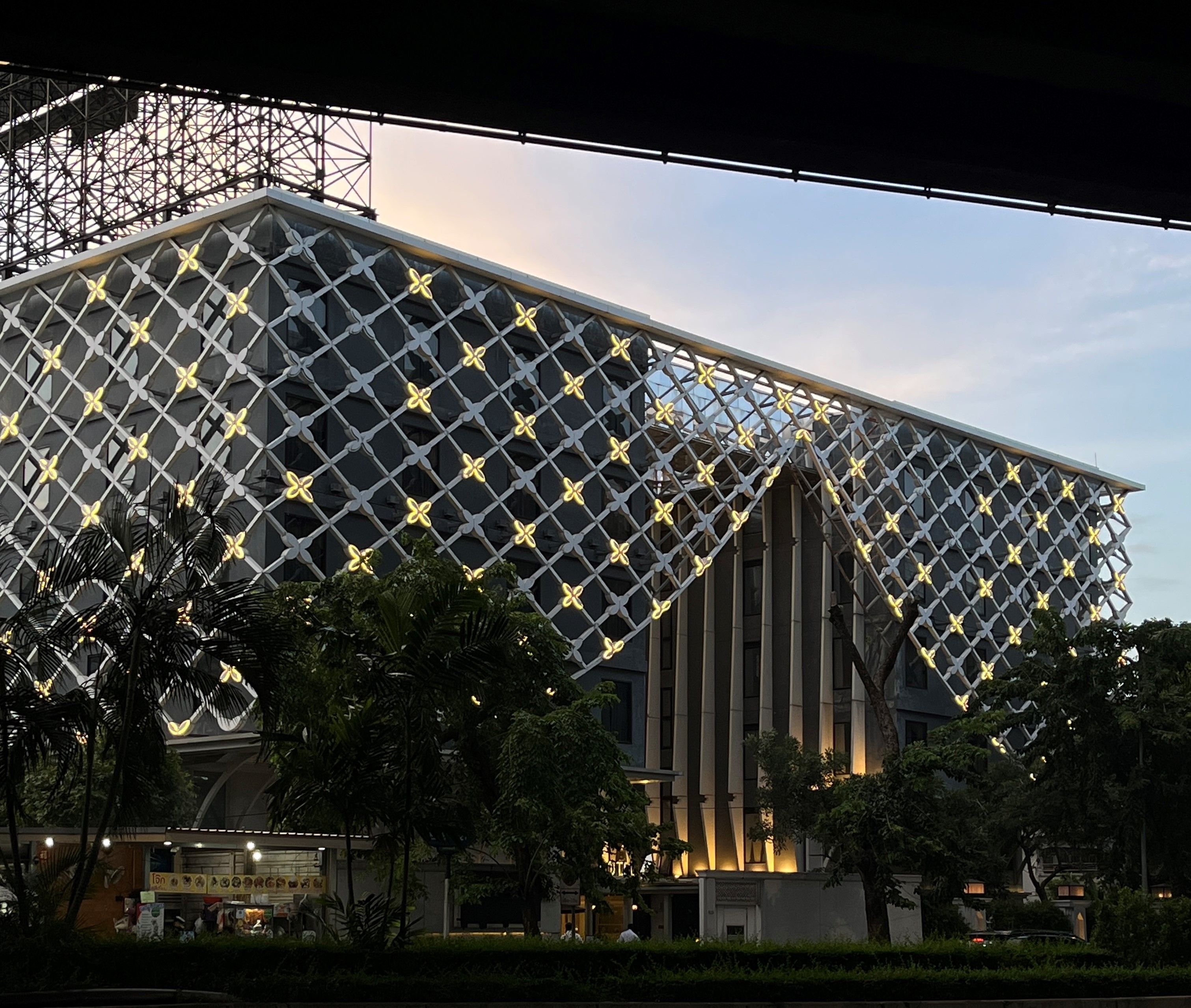A modern building with a distinctive geometric facade and a prominent entrance.