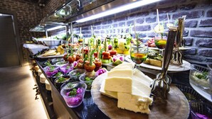 A buffet with various food items and drinks.