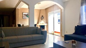Luxury Apartment, 1 Bedroom, Terrace | Living room | Flat-screen TV, fireplace, pay films - Luxurious Apartment with Private Garden (Casablanca)