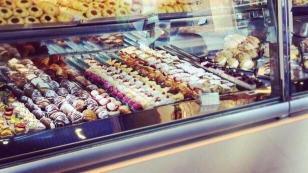 A bakery display case with various pastries and desserts. - B&B Jonio Roma (Rome)