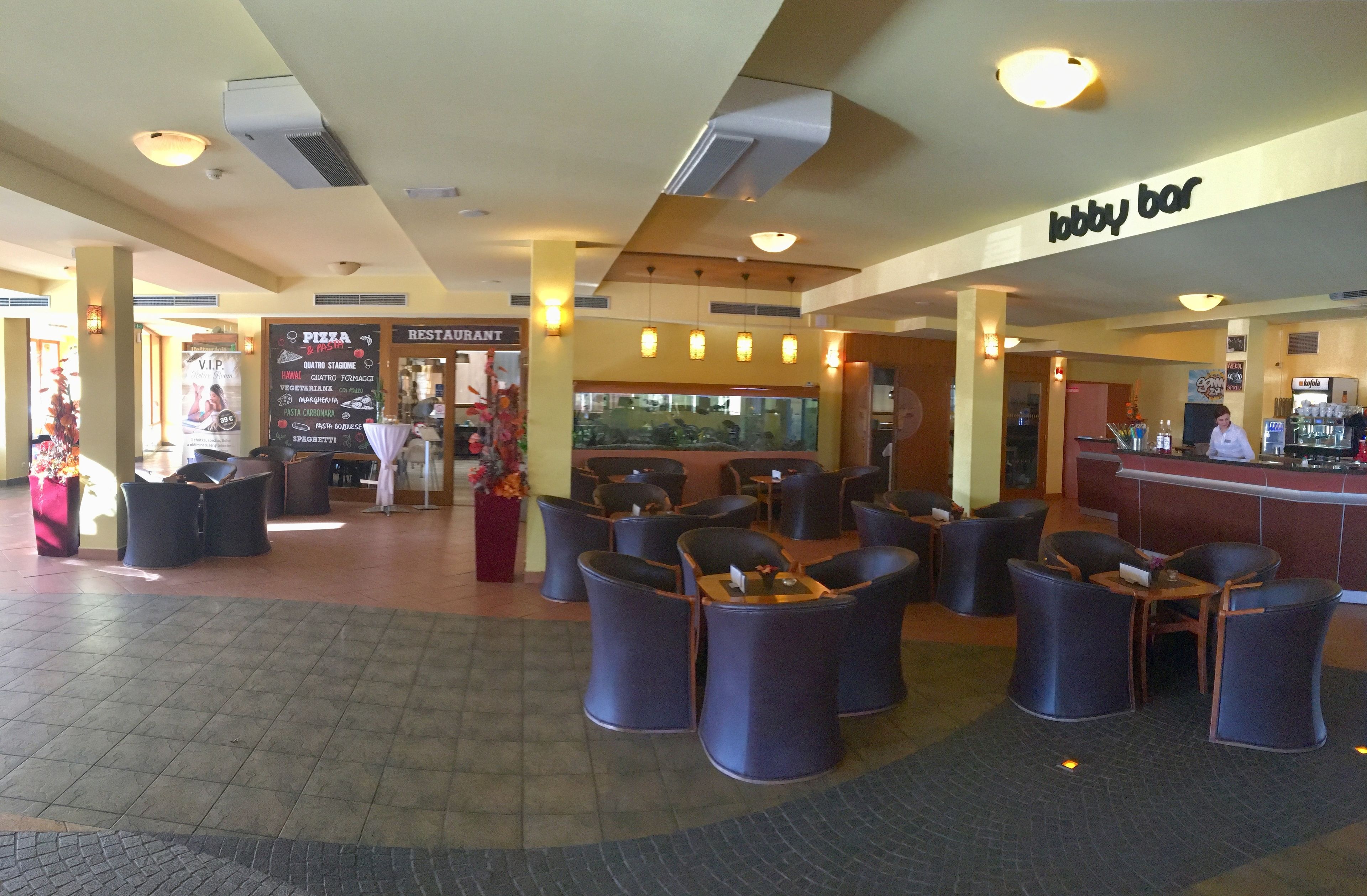 A lobby area with seating arrangements, a VIP section, and a restaurant.