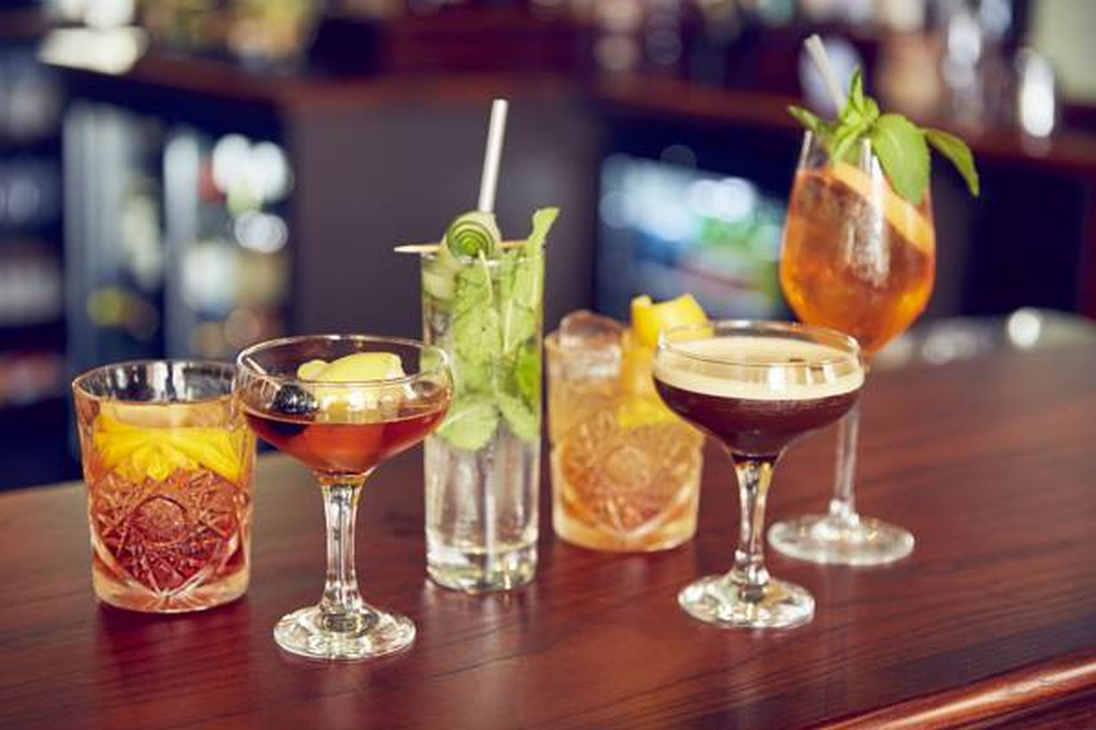 A bar with various drinks in different glasses.