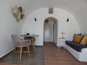 Traditional Apartment, Jetted Tub (Caldera View) | Living area | 24-inch flat-screen TV with satellite channels, TV - Aspa Caves (Santorini)