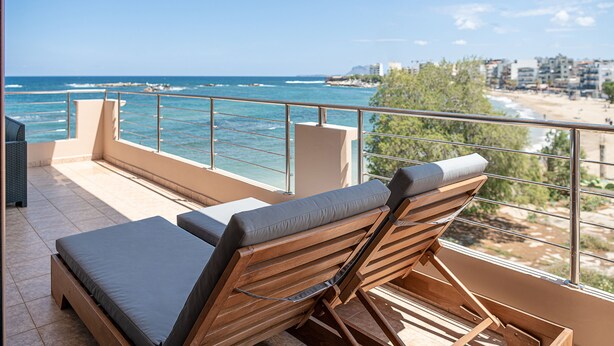 A balcony with two wooden lounge chairs and a view of the sea. - Elia Seaside Nea Chora (Chania)