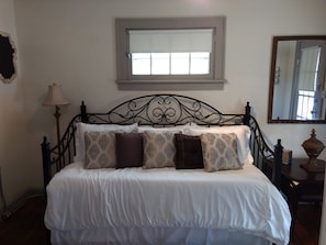 A bed with a white duvet, patterned pillows, and a metal headboard. - Beautiful Downtown Indy Guest Homes (Indianapolis)