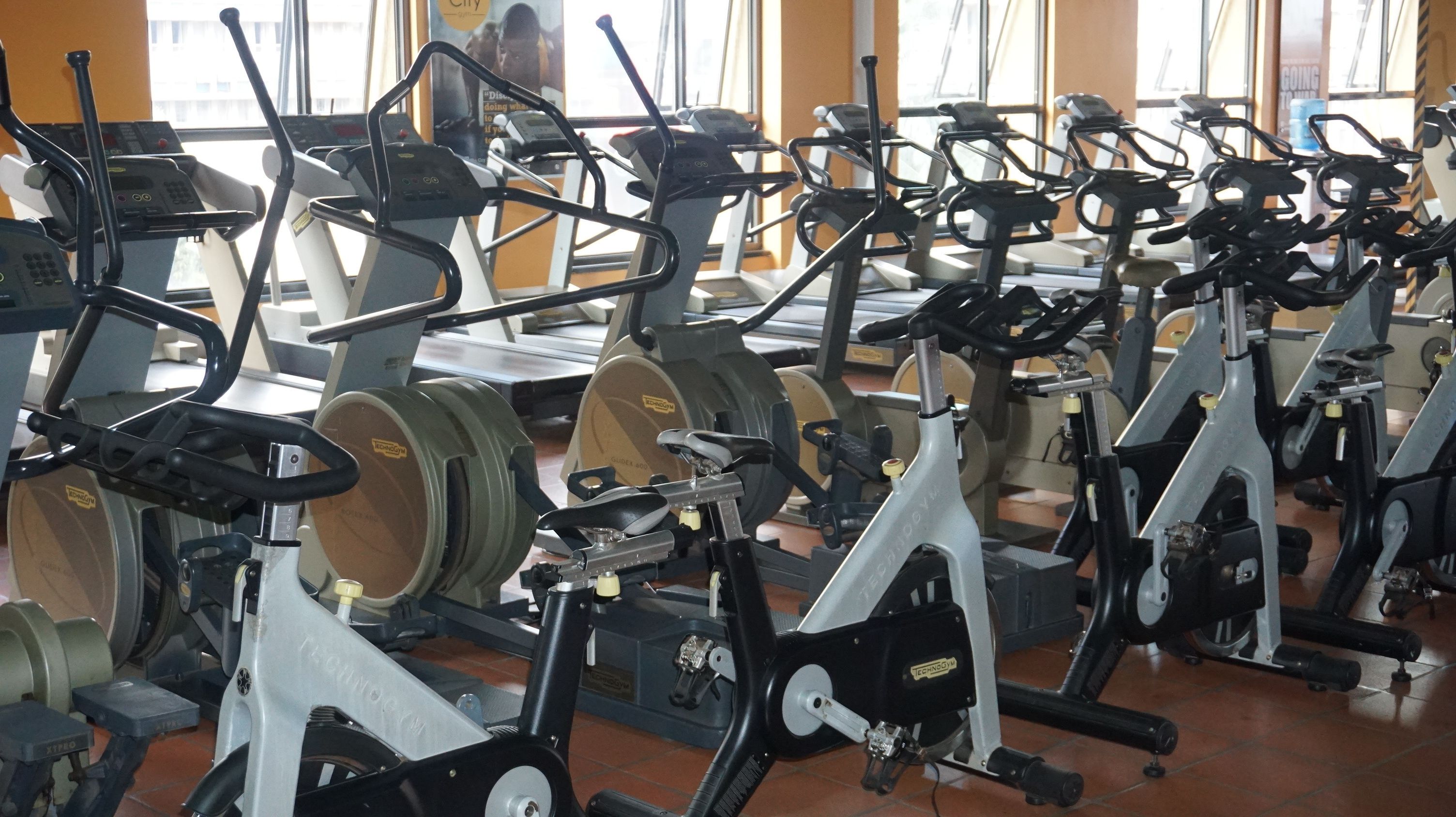 Ein Fitnessstudio mit mehreren Fahrrädern und Laufbändern.
