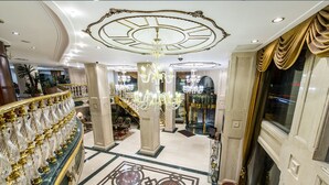 A grand lobby with a marble floor, a staircase, and a chandelier. - Akar International Hotel (Ankara)