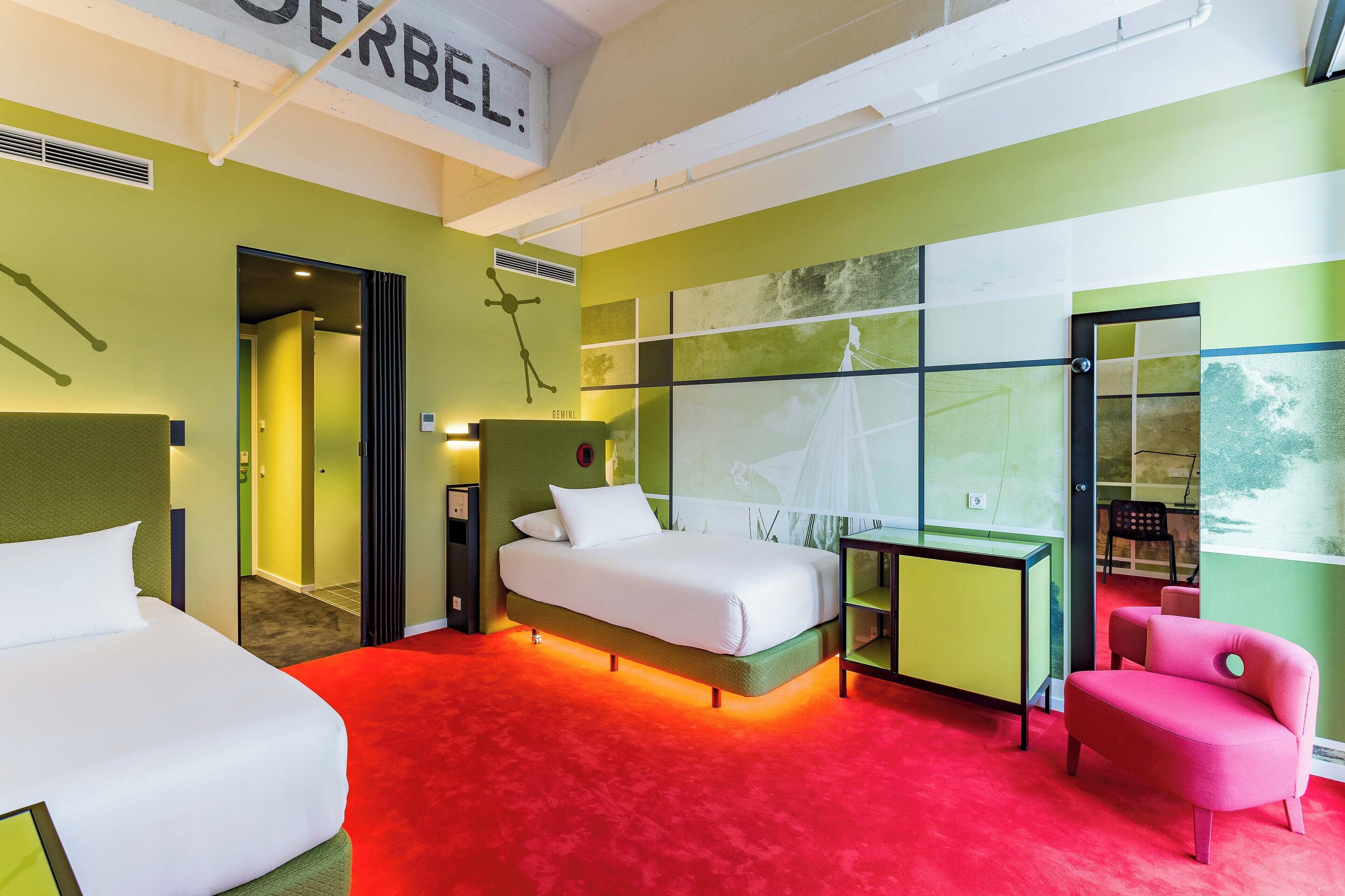 A hotel room with a large bed, a desk, a chair, and a view of the outdoors.