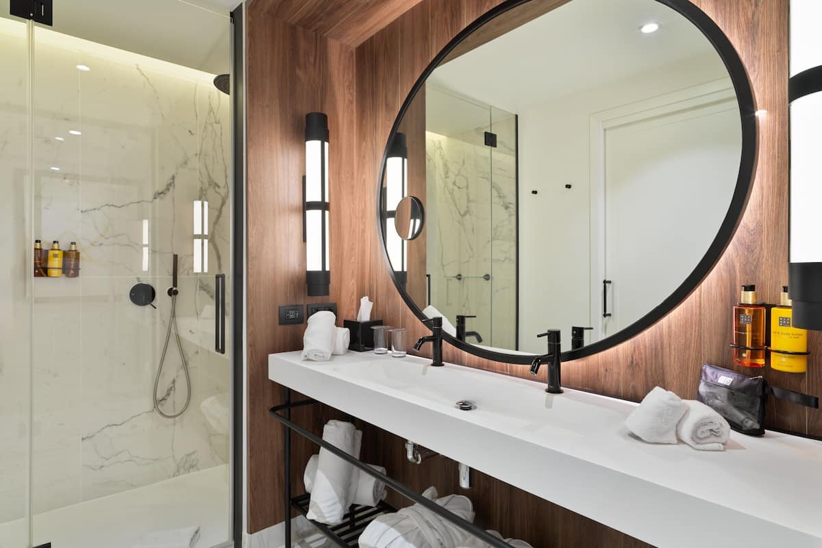 shower, designer toiletries, hair dryer, towels