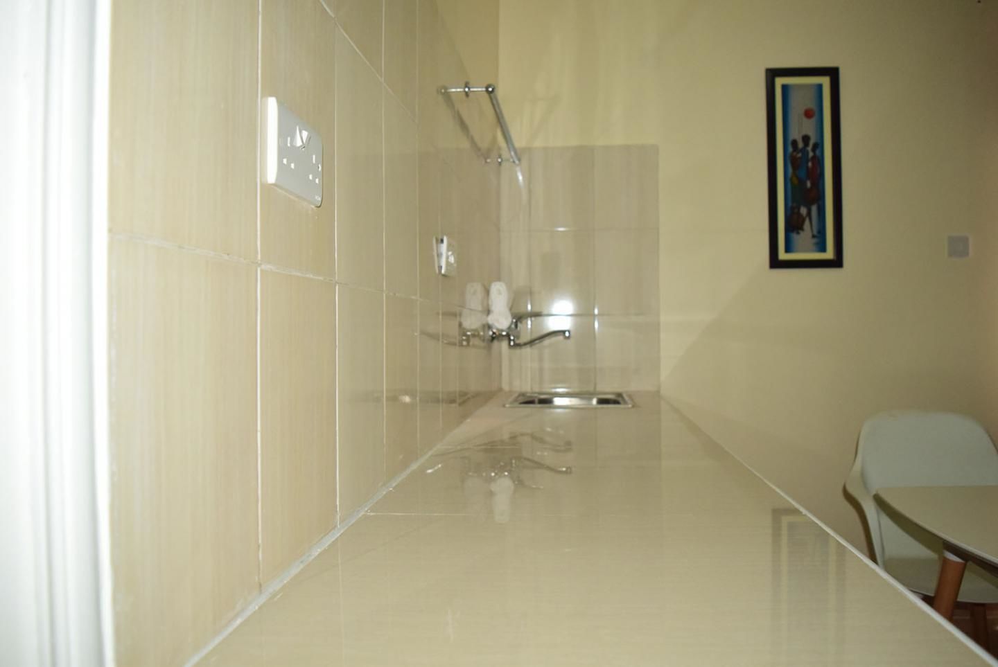A bathroom with a shower, a toilet, and a sink.