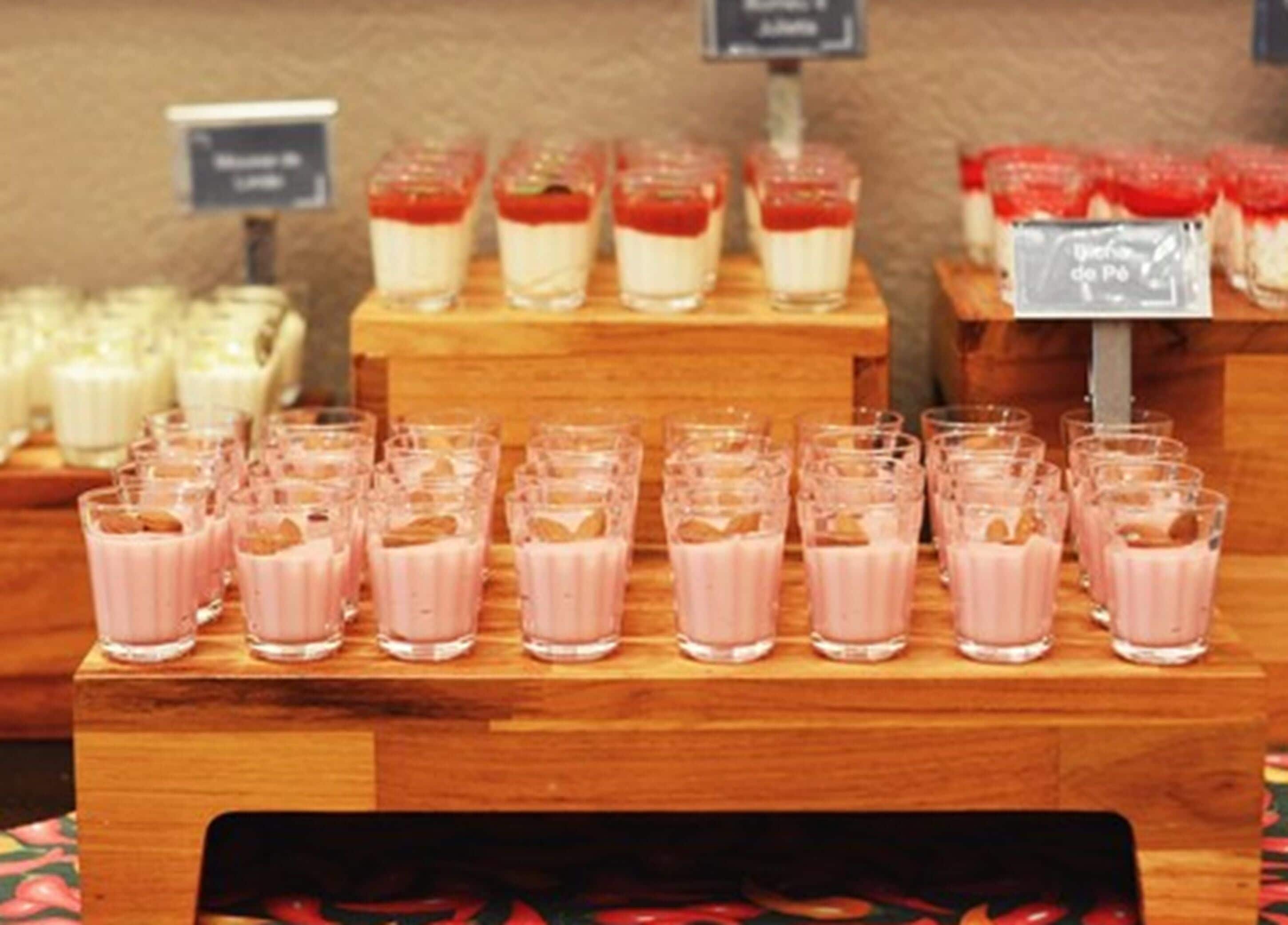 A dessert display with various types of desserts in glasses.