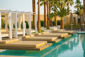 Seasonal outdoor pool, open 10:00 AM to 7:00 PM, pool umbrellas