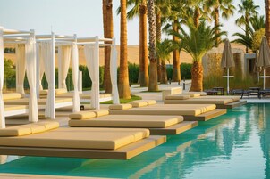 Seasonal outdoor pool, open 10:00 AM to 7:00 PM, pool umbrellas