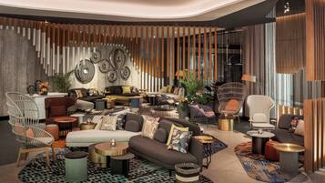 A modern living room with a sectional sofa, armchairs, and a coffee table.