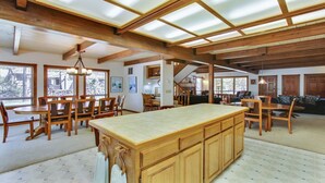 A spacious kitchen with a large island, wooden cabinets, and a high ceiling with skylights. - 2 Tokatee-Sunriver, Oregon: Hot Tub, BBQ, WiFi, SHARC Aquatics, Tubing Hill, Mt. Bachelor, Golf, Deschutes River, Tennis, Bike Paths (Sunriver)