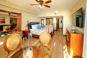 A spacious bedroom with a large bed, wooden furniture, and a ceiling fan. - Somewhere on the Beach a dream property all amenities included simply amazing (Key West)
