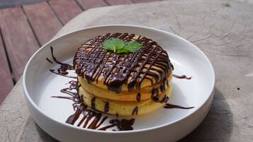 A dessert on a plate with a pool in the background.