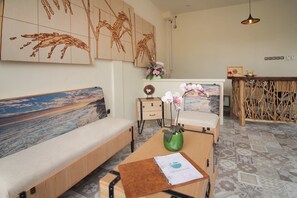 Relax in a stylish room with a sofa offering a scenic view, a coffee table, and a side table with decorative accents.