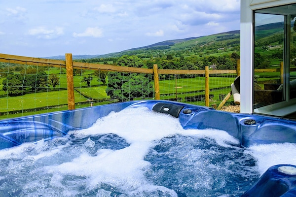 Relax in the hot tub whilst taking in the stunning views