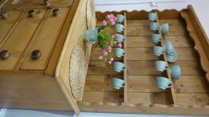 A wooden tray with multiple ceramic cups and a small bouquet of pink flowers. - A delightful country house set in the heart of Lakeland (Keswick)