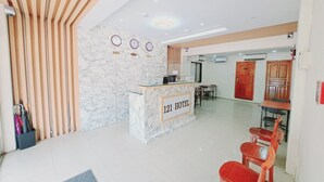 A hotel reception area with a marble counter, wooden slats, and a '121 HOTEL' sign. - 121 Hotel Yangon (Yangon)