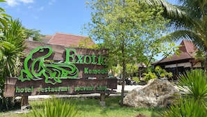 A sign for Exotica Komodo, indicating it is a hotel, restaurant, and souvenir shop. - Exotic Komodo Hotel (Labuan Bajo)